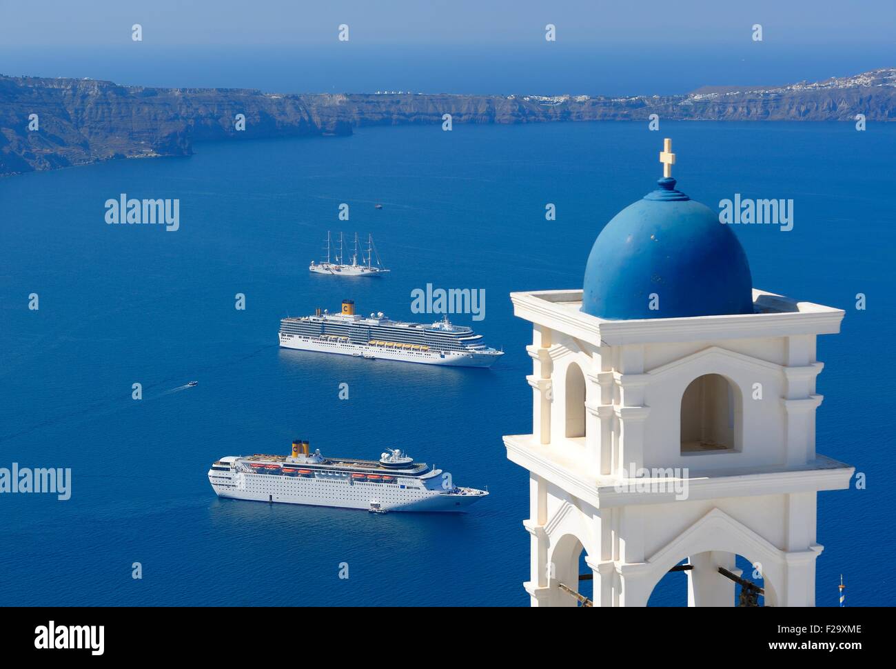 The Anastasi Church bell tower and Cruise ships Costa classica in the foreground and Costa deliziosa in the Caldera Santorini Stock Photo