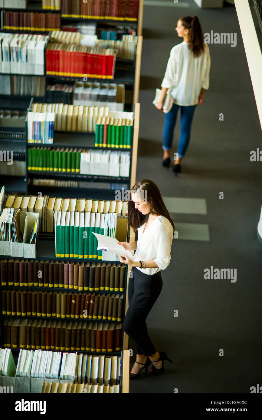 Young women in the library Stock Photo - Alamy