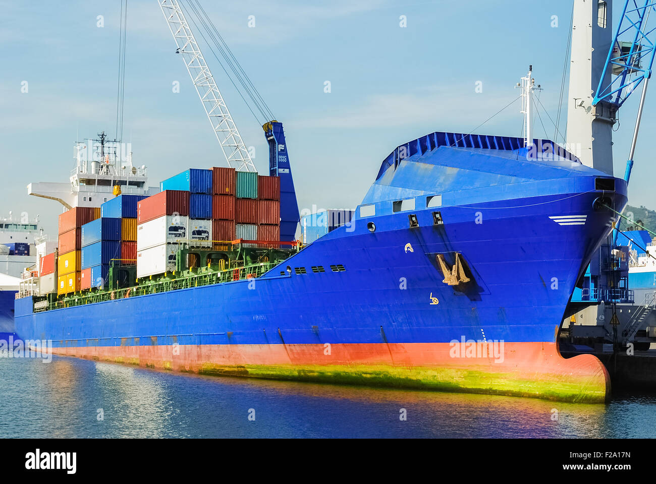 Freighter with containers at the harbor of Genoa Stock Photo
