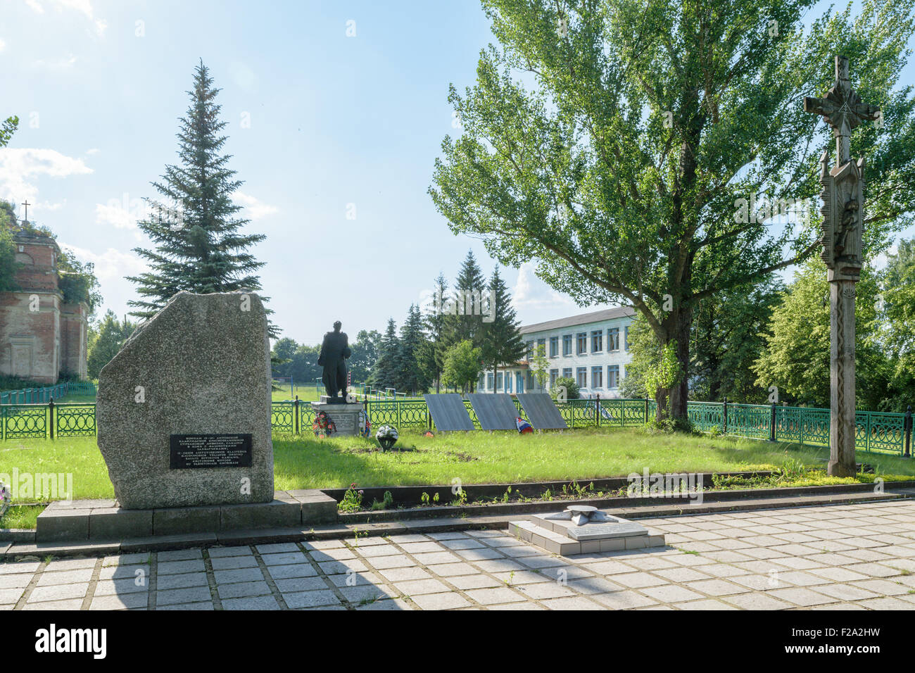 Mass grave and memorial to soldiers of the 16th Lithuanian Klaipeda Red Banner Rifle Division. Local school in the background Stock Photo