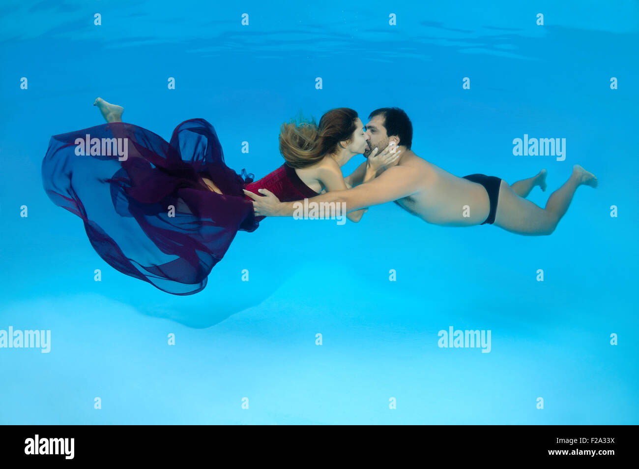 Man and woman kissing under water, Underwater fasihon in the pool, Odessa, Ukraine Stock Photo