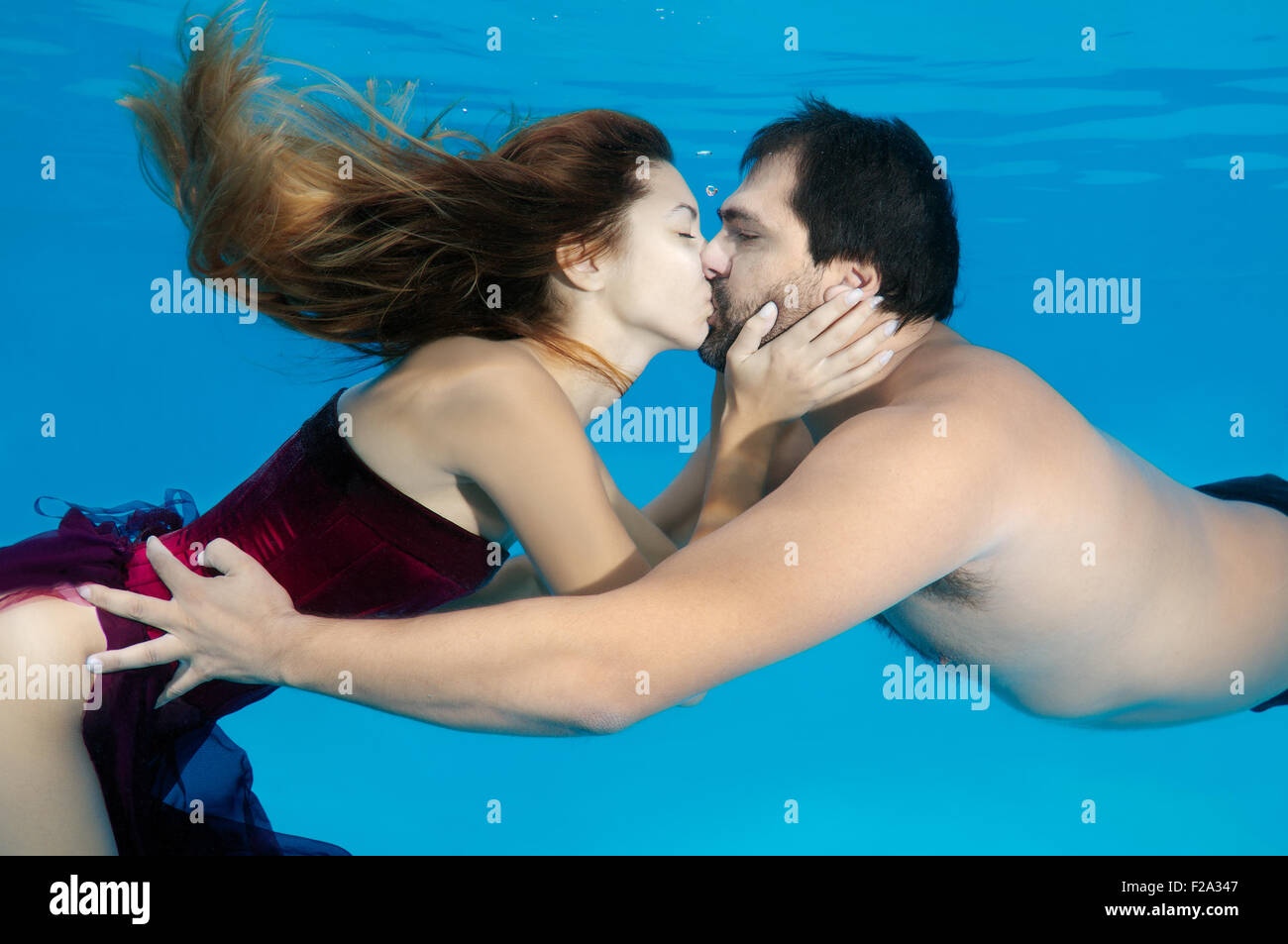 Man and woman kissing under water, Underwater fasihon in the pool, Odessa, Ukraine Stock Photo
