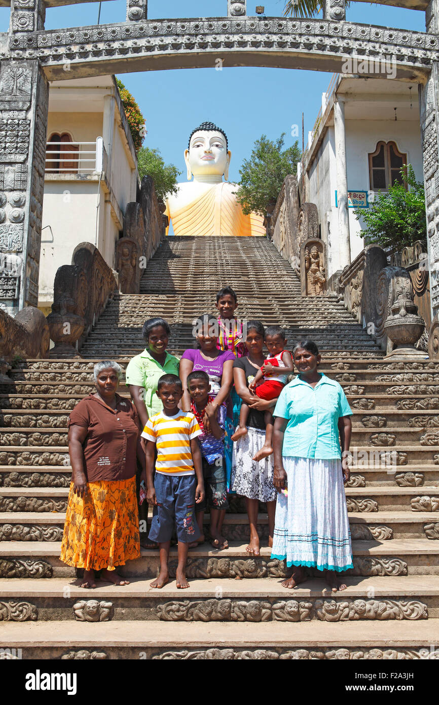 Women and children on the stairs to the Great Buddha, Kandavihara Temple, Beruwela, Western Province, Ceylon, Sri Lanka Stock Photo