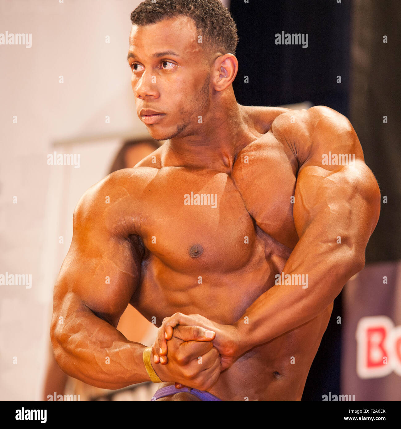 SCHIEDAM, THE NETHERLANDS - APRIL 26, 2015. Male bodybuilder shows his best chest pose on stage Stock Photo