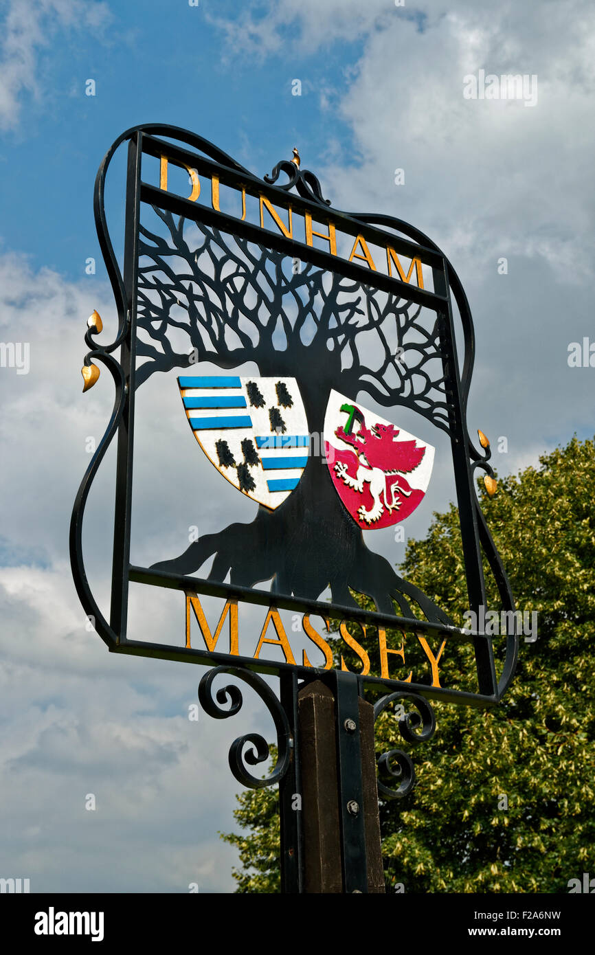 Village sign of Dunham Massey with Coat of Arms at Dunham Town, Altrincham, Trafford in Greater Manchester. Stock Photo