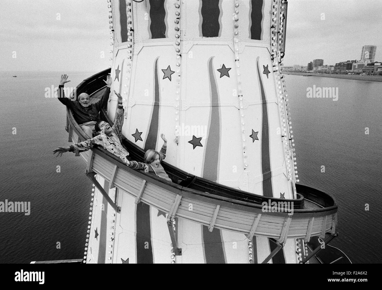 Brighton Artist Philip Dunn, Punch and Judy man Sgt Stone and a Brighton schoolgirl on the helter skelter ride on Brighton's Palace Pier in 1994. Stock Photo