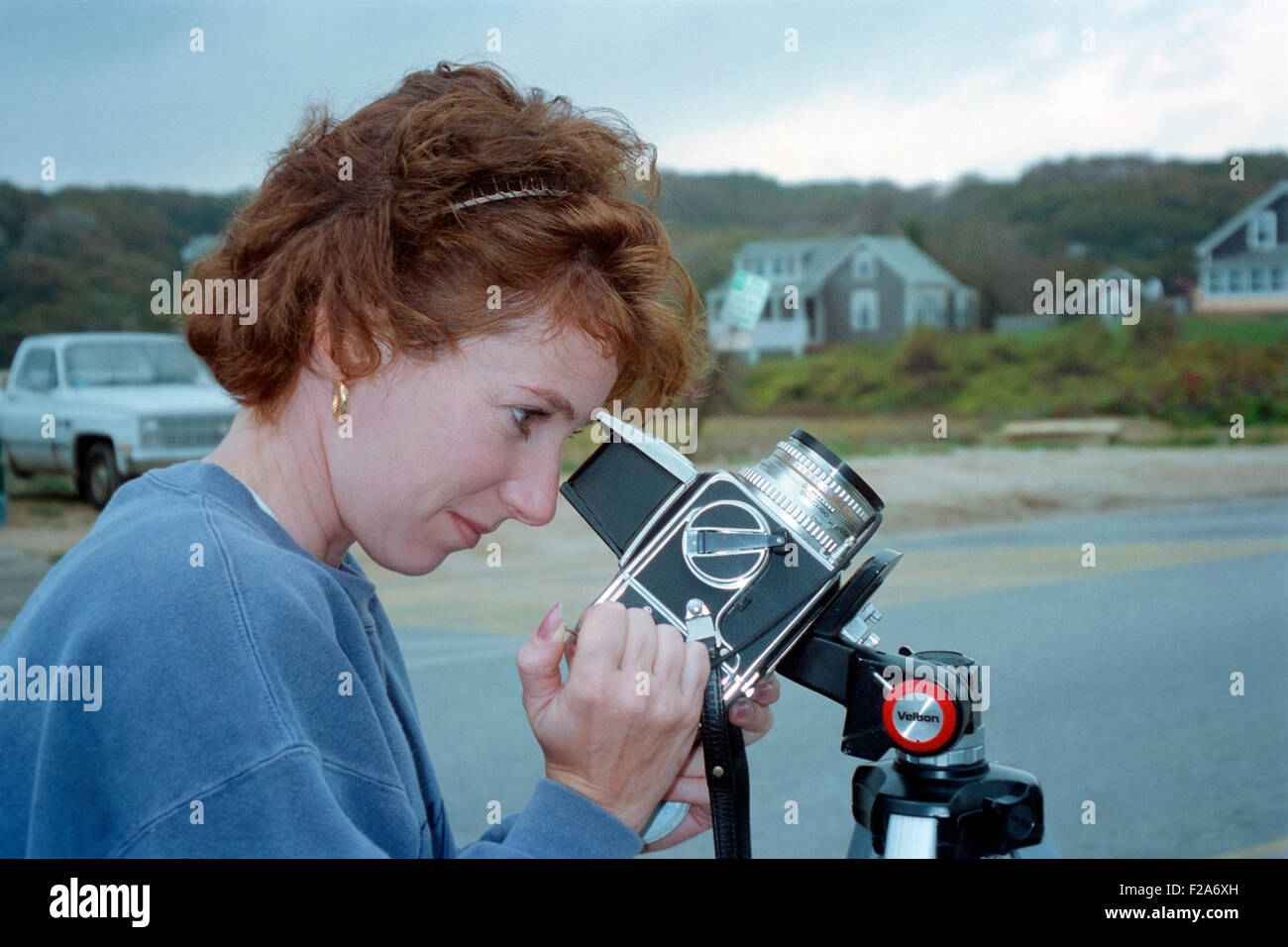 young female using a hasselblad camera on a tripod in marthas vineyard usa Stock Photo
