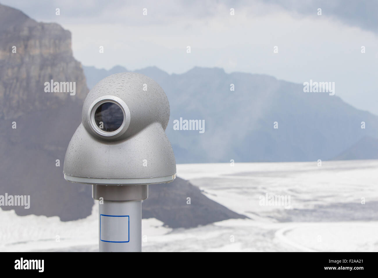 Binoculars against the grey sky, high up in the Alps, Switzerland Stock Photo
