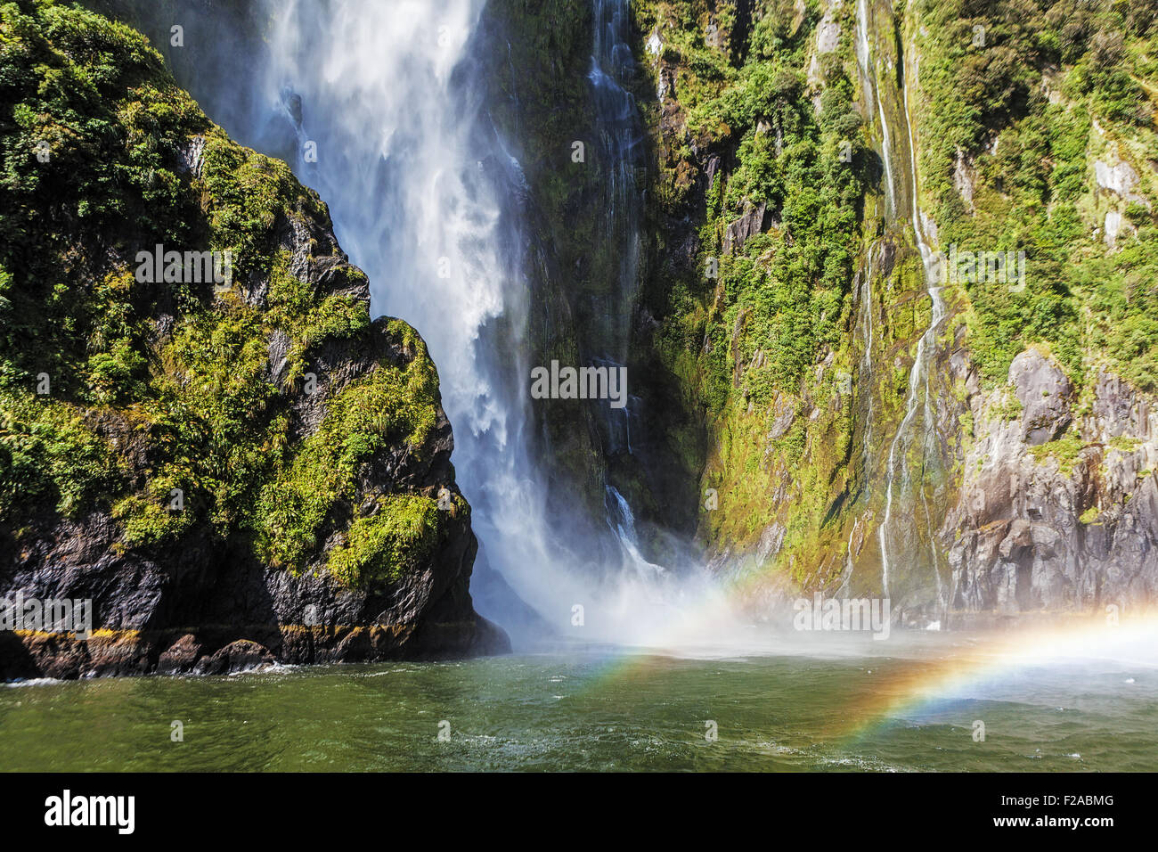 Incredible Stirling Falls with double rainbow, Milford Sound, Fiordland, South Island, New Zealand Stock Photo