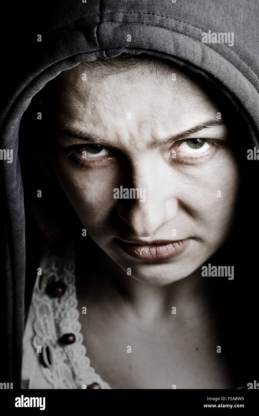 Scary sinister woman with evil eyes Stock Photo