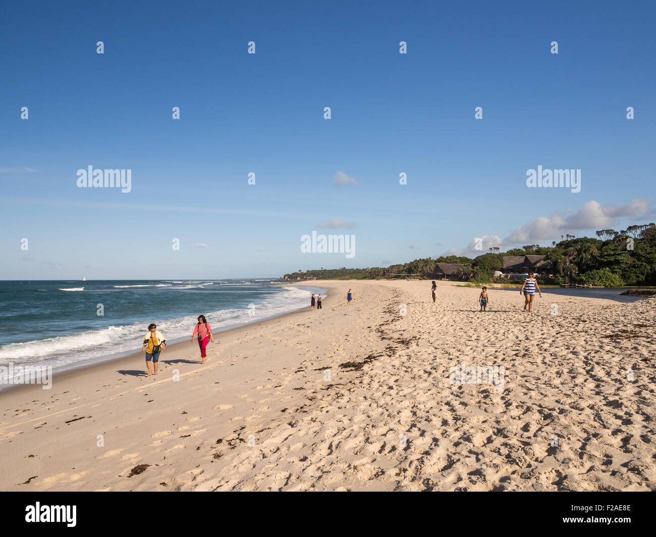 People walking on the Kutani beach in Dar es Salaam, Tanzania, on a sunny day. Stock Photo