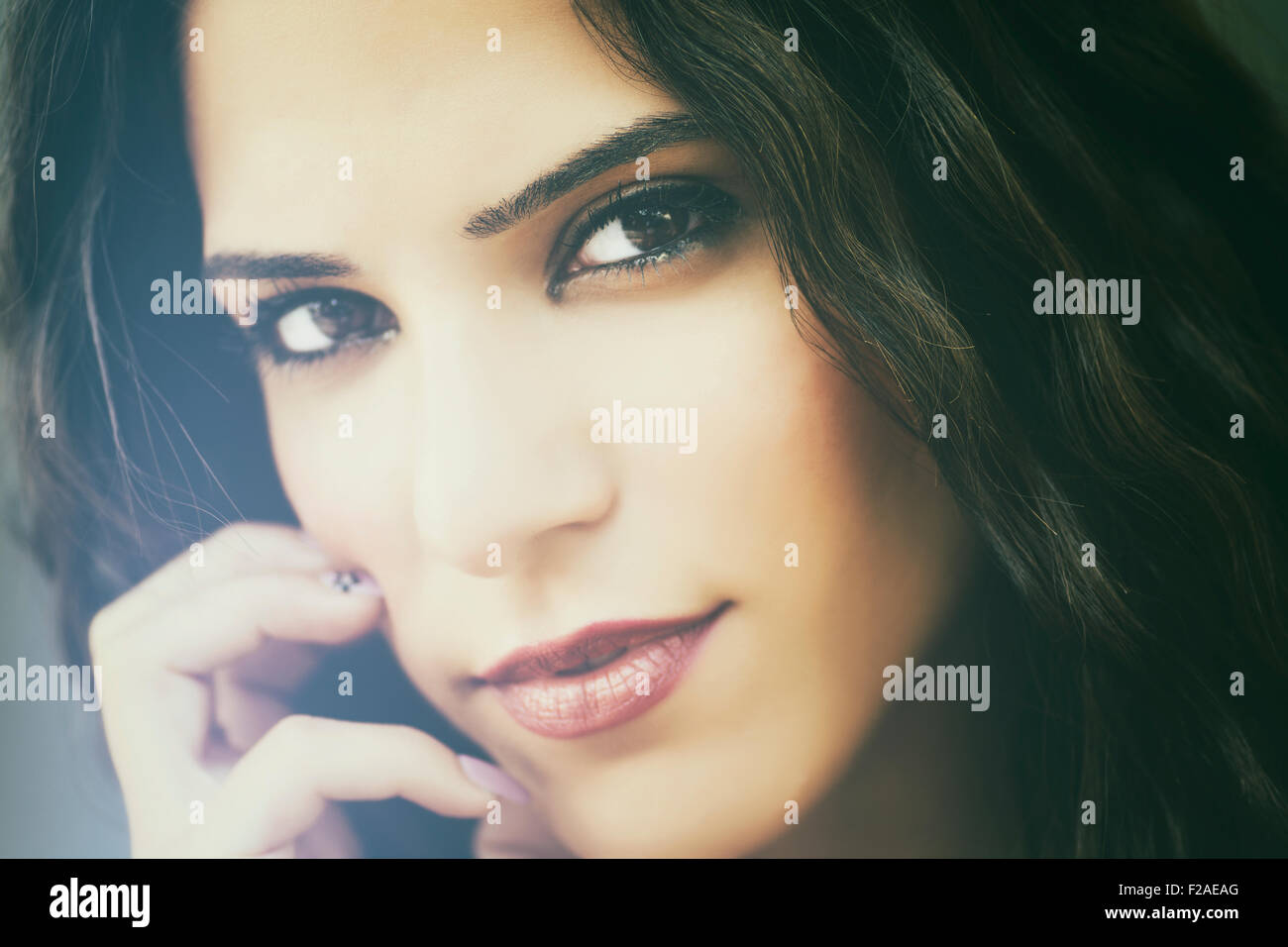 Beautiful young woman hand touching face Stock Photo - Alamy