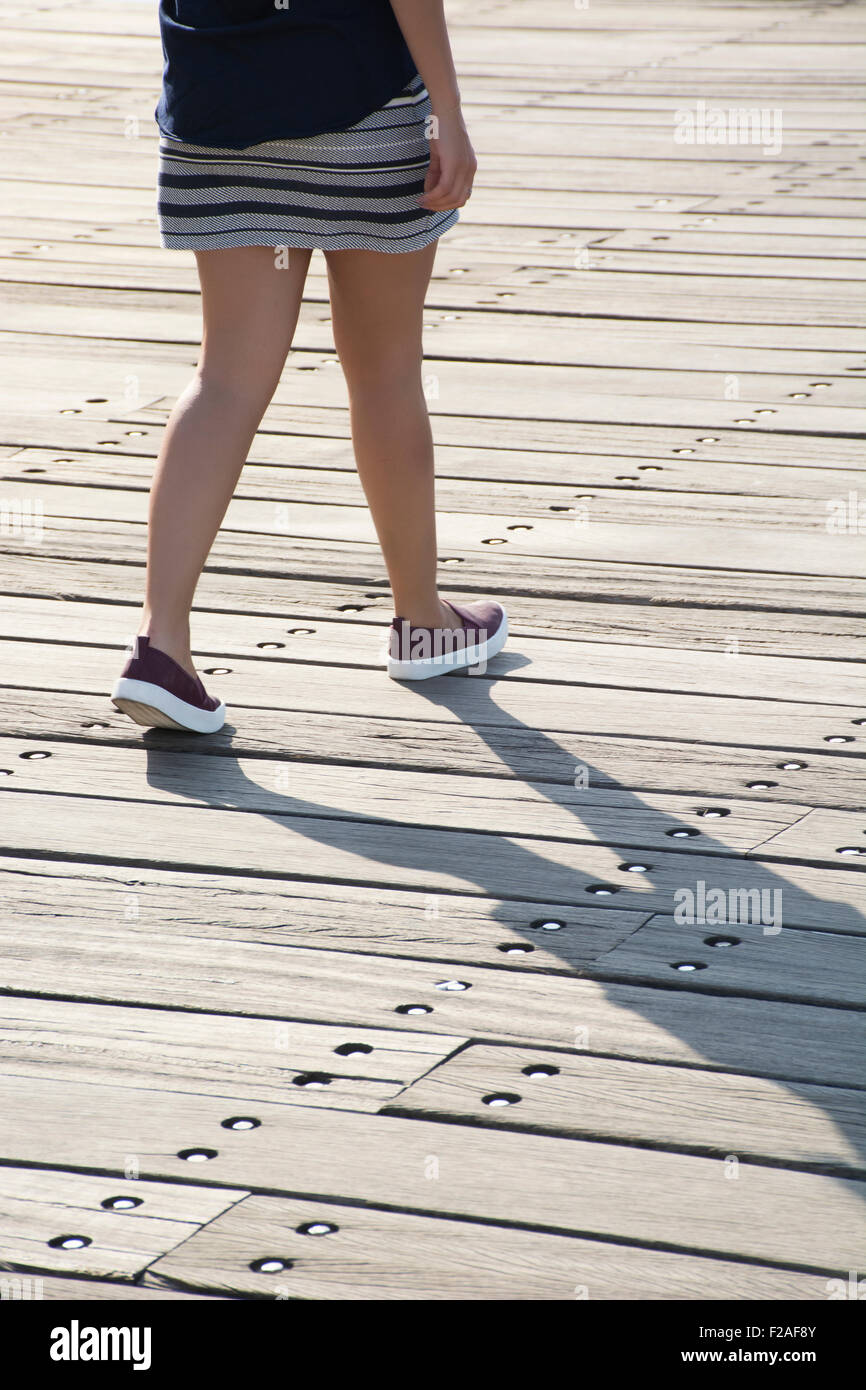 young woman walking outdoors Stock Photo
