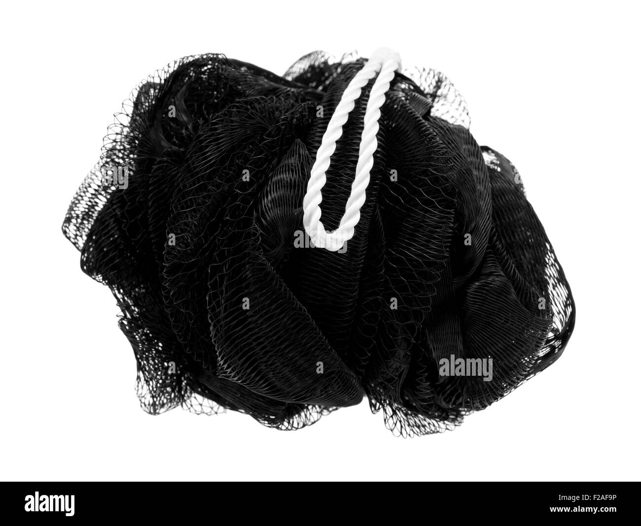A plastic black exfoliating mesh sponge with a loop for drying isolated on a white background. Stock Photo