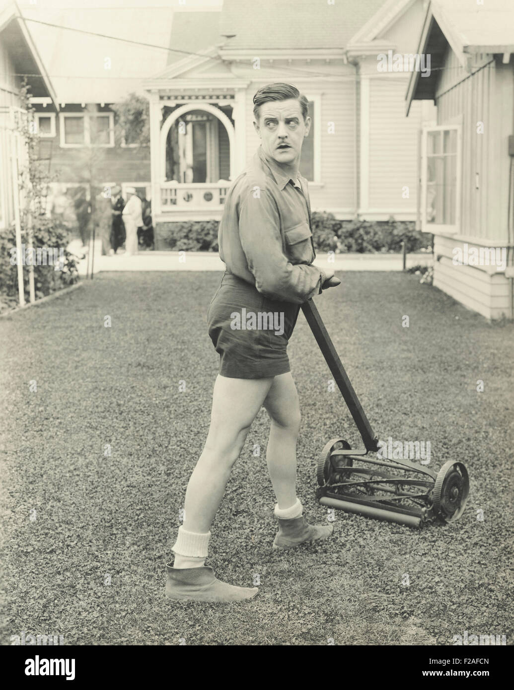 Suspicious man with a push reel lawn mower (OLVI008 OU474 F Stock