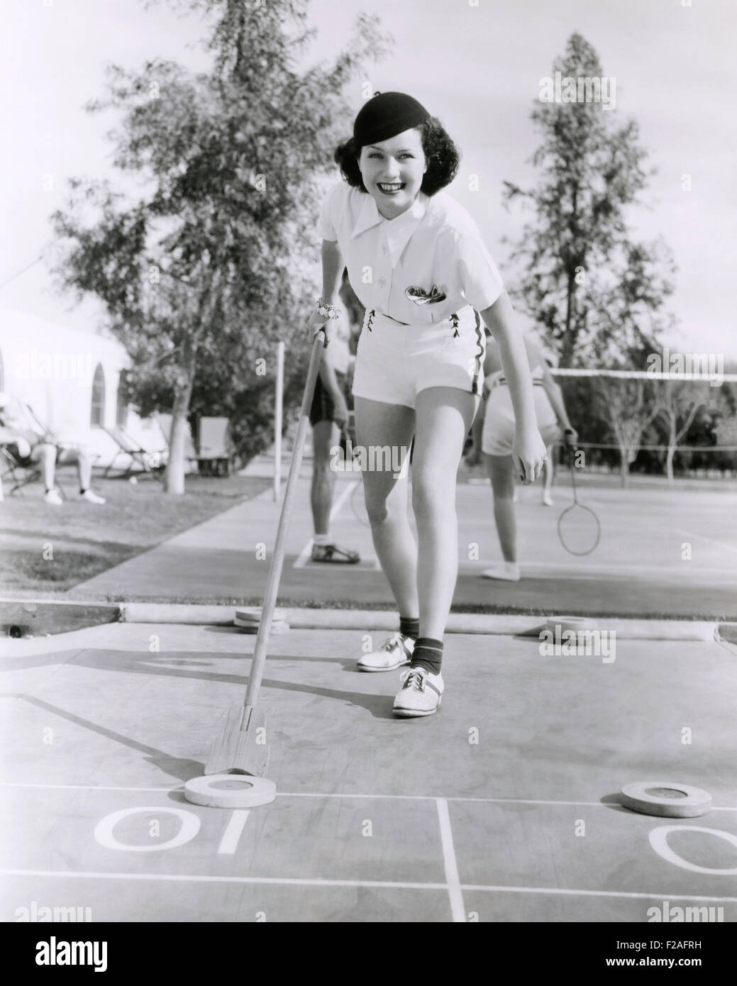 Woman enjoying a game of shuffleboard (OLVI008 OU329 F) Stock Photo