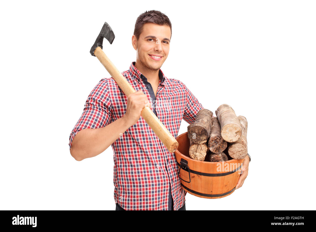 Young man carrying an ax over his shoulder and holding a bucket full of logs isolated on white background Stock Photo