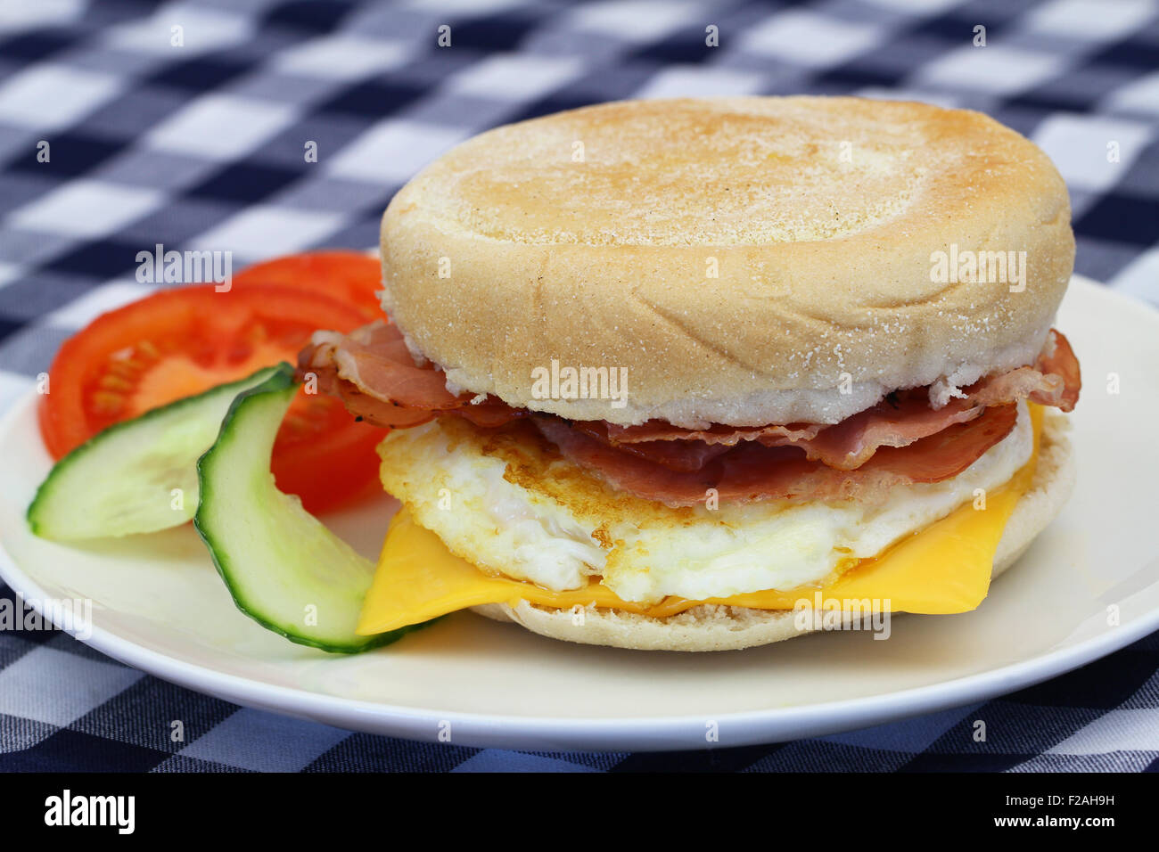 Egg and bacon muffin on white plate, closeup Stock Photo