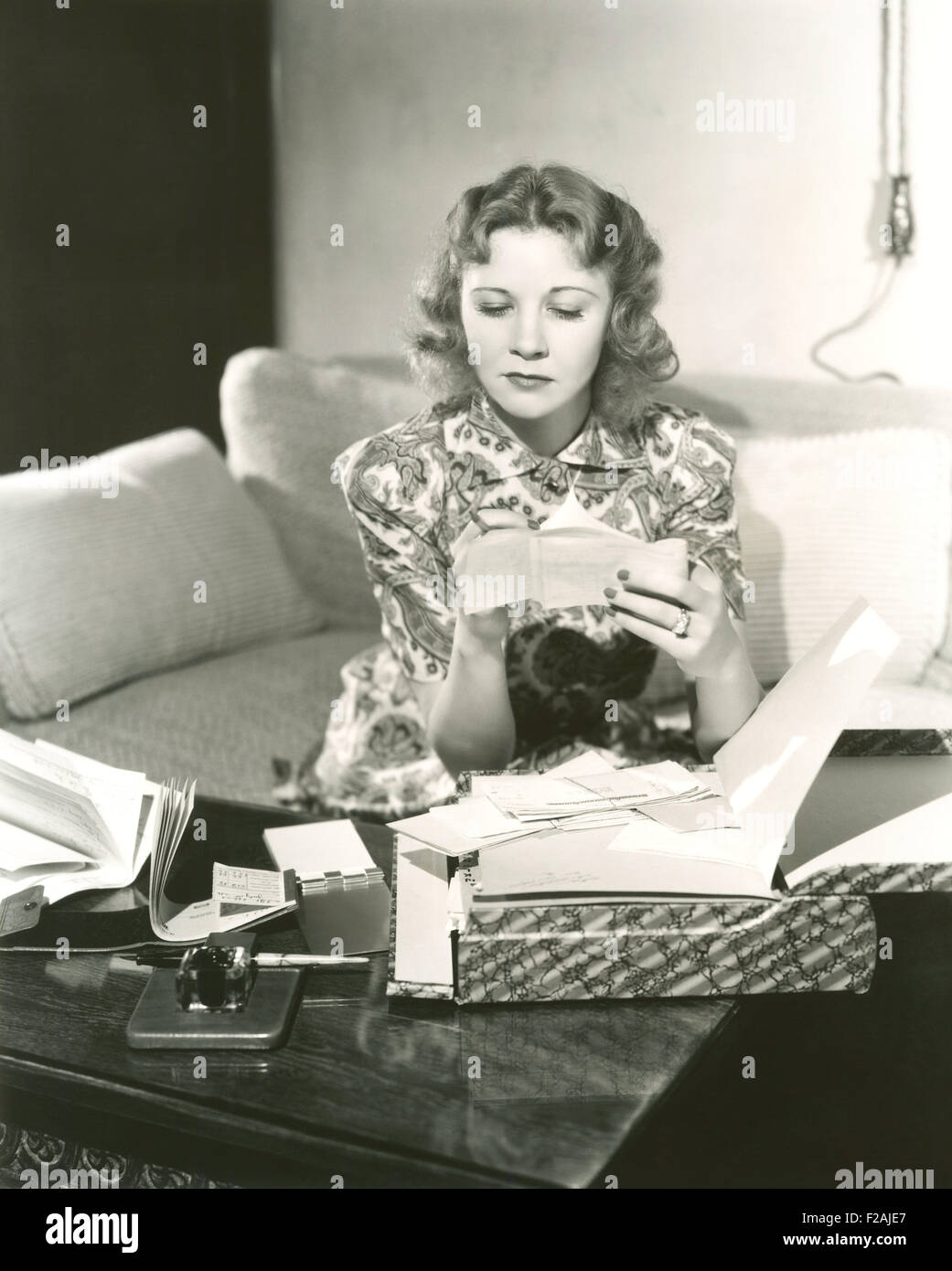 Going over the bills (OLVI007 OU791 F) Stock Photo