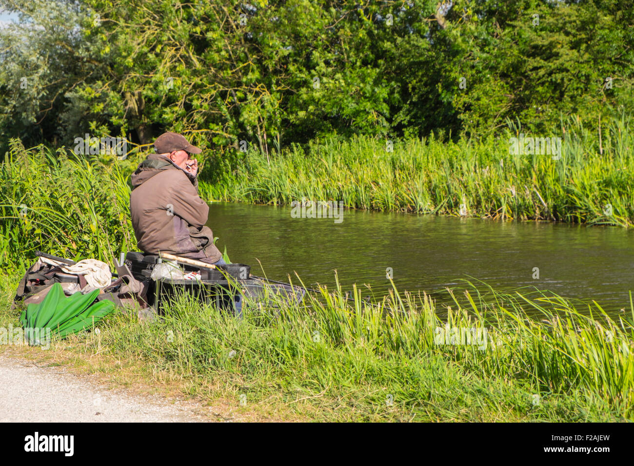 Fisherman, coarse fishing with equipment on the bank of Grantham canal, Hickling, Nottinghamshire. UK Stock Photo