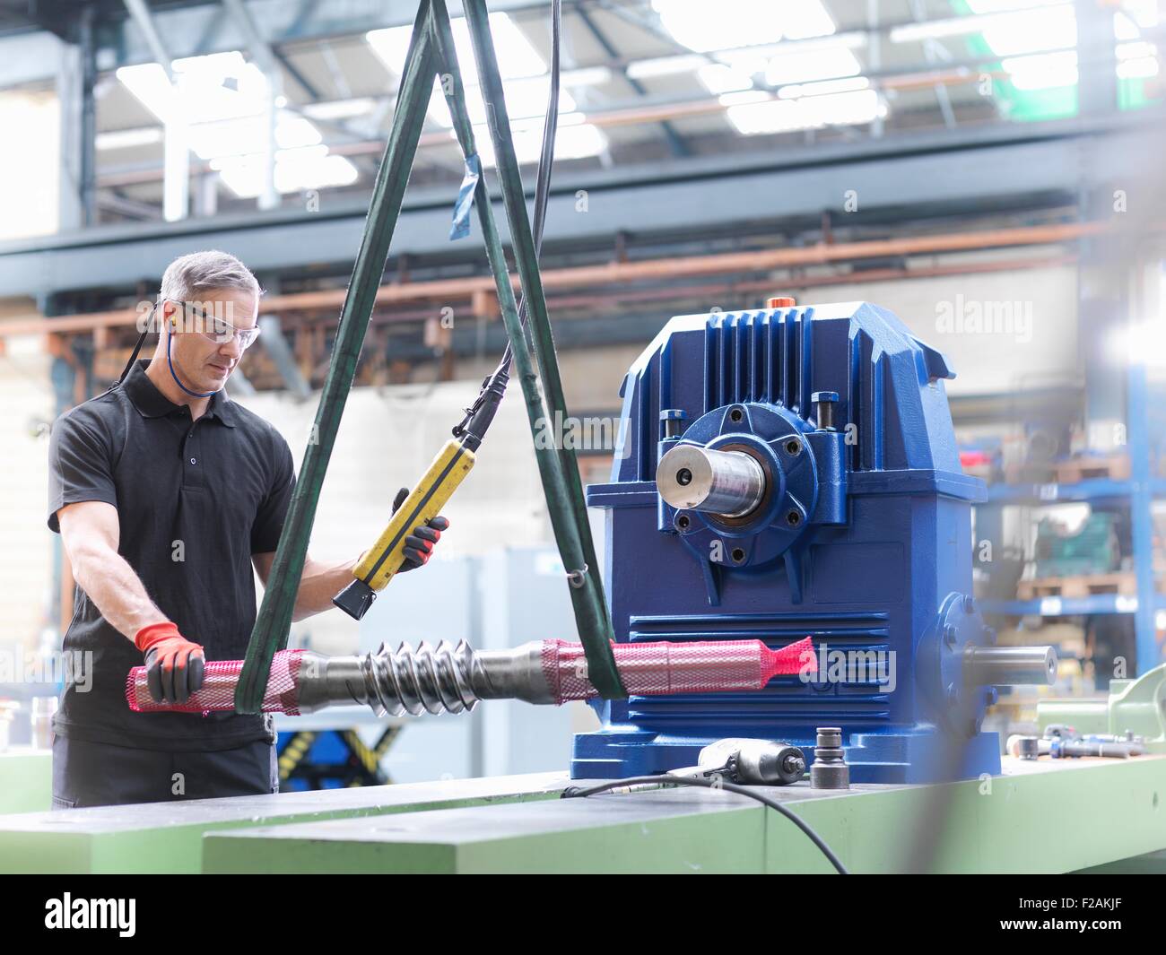 Engineer assembling industrial gearbox in engineering factory Stock Photo