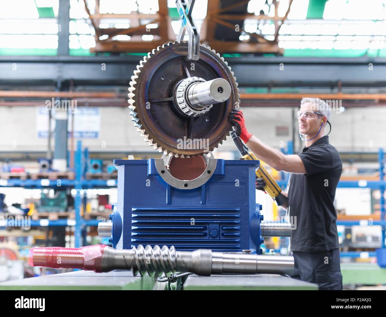 Engineer assembling industrial gearbox in engineering factory Stock