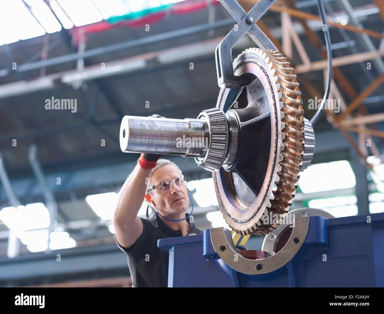 Engineer assembling industrial gearbox in engineering factory Stock Photo