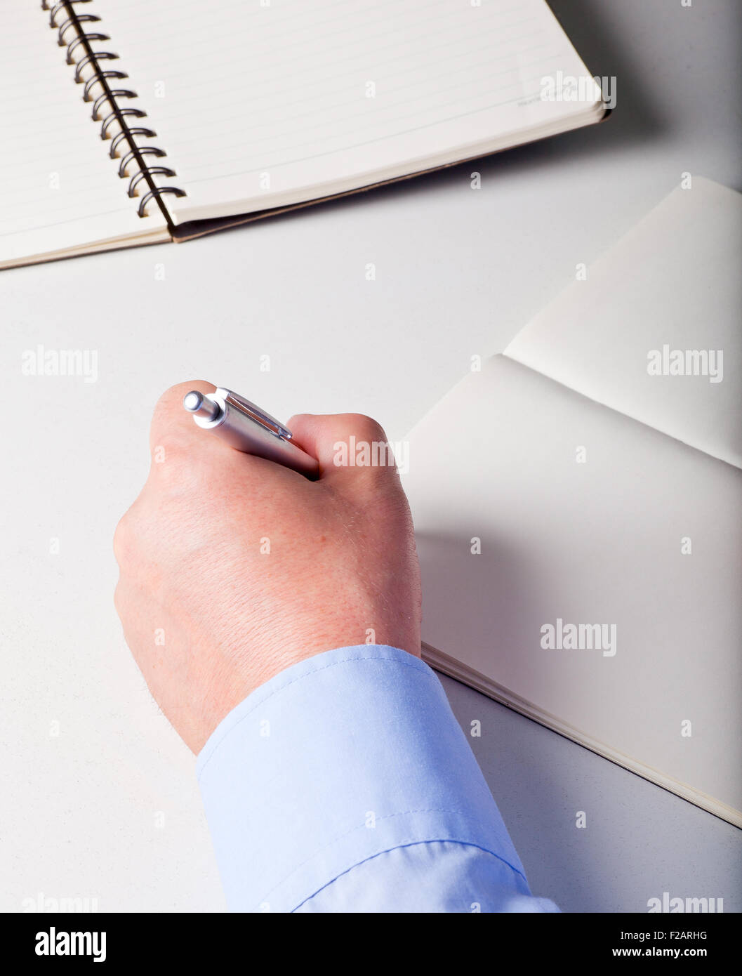 Hands of a man writing with a pen on a diaries Stock Photo