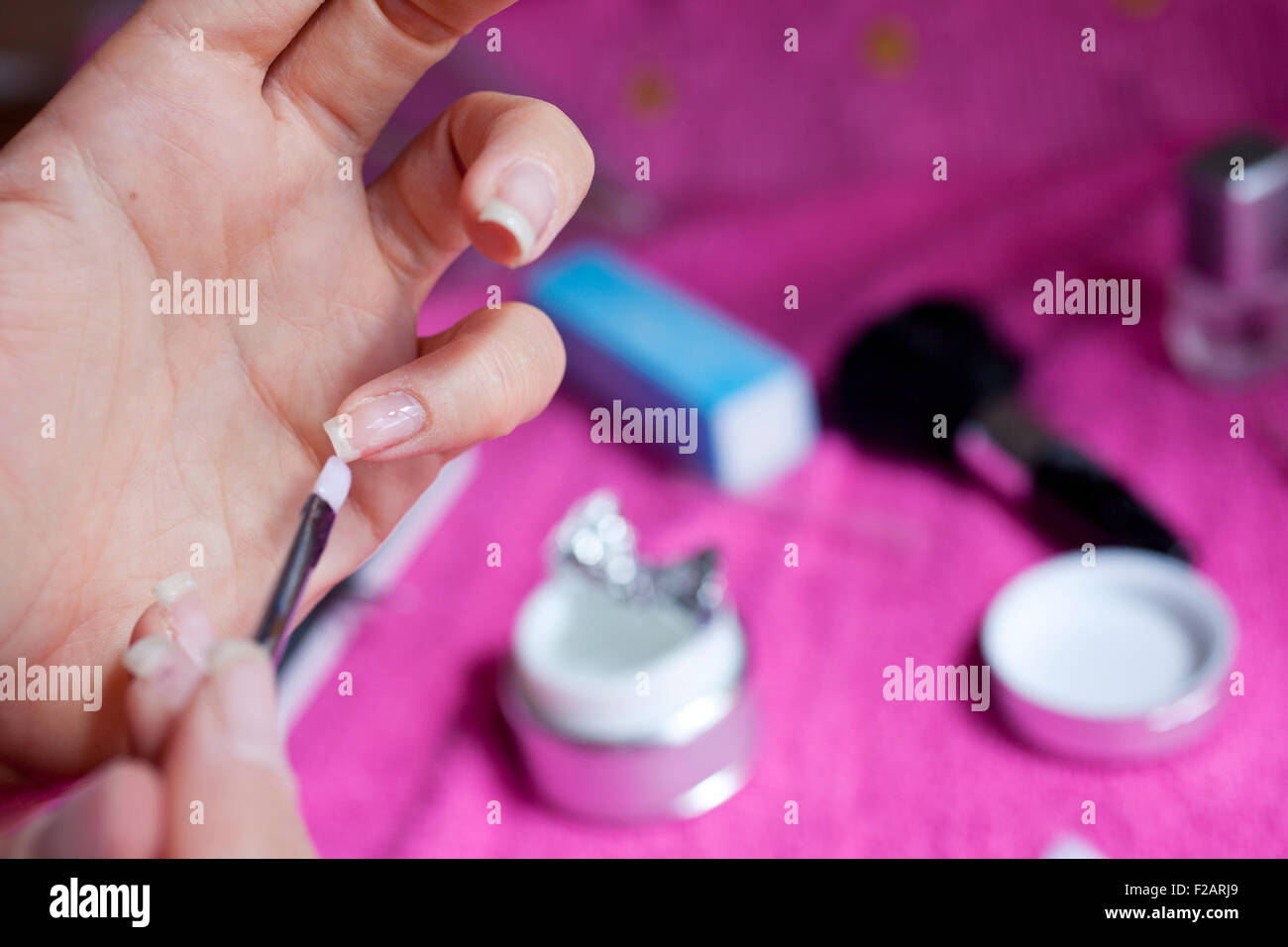A Woman painting her nails Stock Photo Alamy