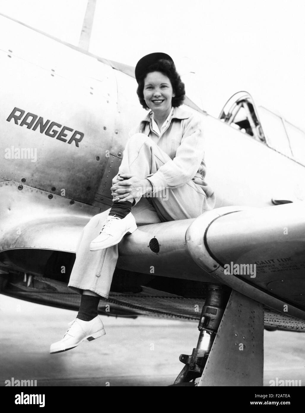 Margaret (Mickey) McGrath, former WASP sitting on the wing of in an XAT-6E trainer aircraft. It was equipped with an experimental Ranger Engine. McGrath and the XAT-6E failed to complete the first lap on Aug. 30, 1947 Hall Trophy race at Cleveland. WASP stands for Women's Airforce Service Personal, a group of women pilots that freed men for combat flying during World War II. (CSU 2015 11 1684) Stock Photo