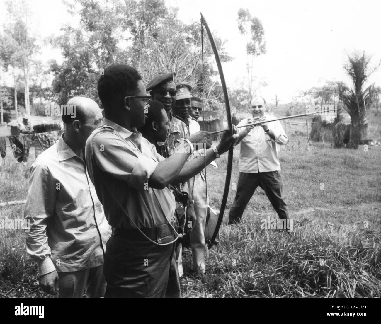Gen. Joseph Mobutu, Chief of the Congolese Army, demonstrates his skill with bow and arrow. March 23, 1964. In 1960 Belgian forces aided his coup d’état that deposed and killed Patrice Lumumba. Colonel Mobutu, used his position as Army Chief of Staff to dominate President Kasa-Vubu who led a weak civilian government. (CSU 2015 11 1557) Stock Photo