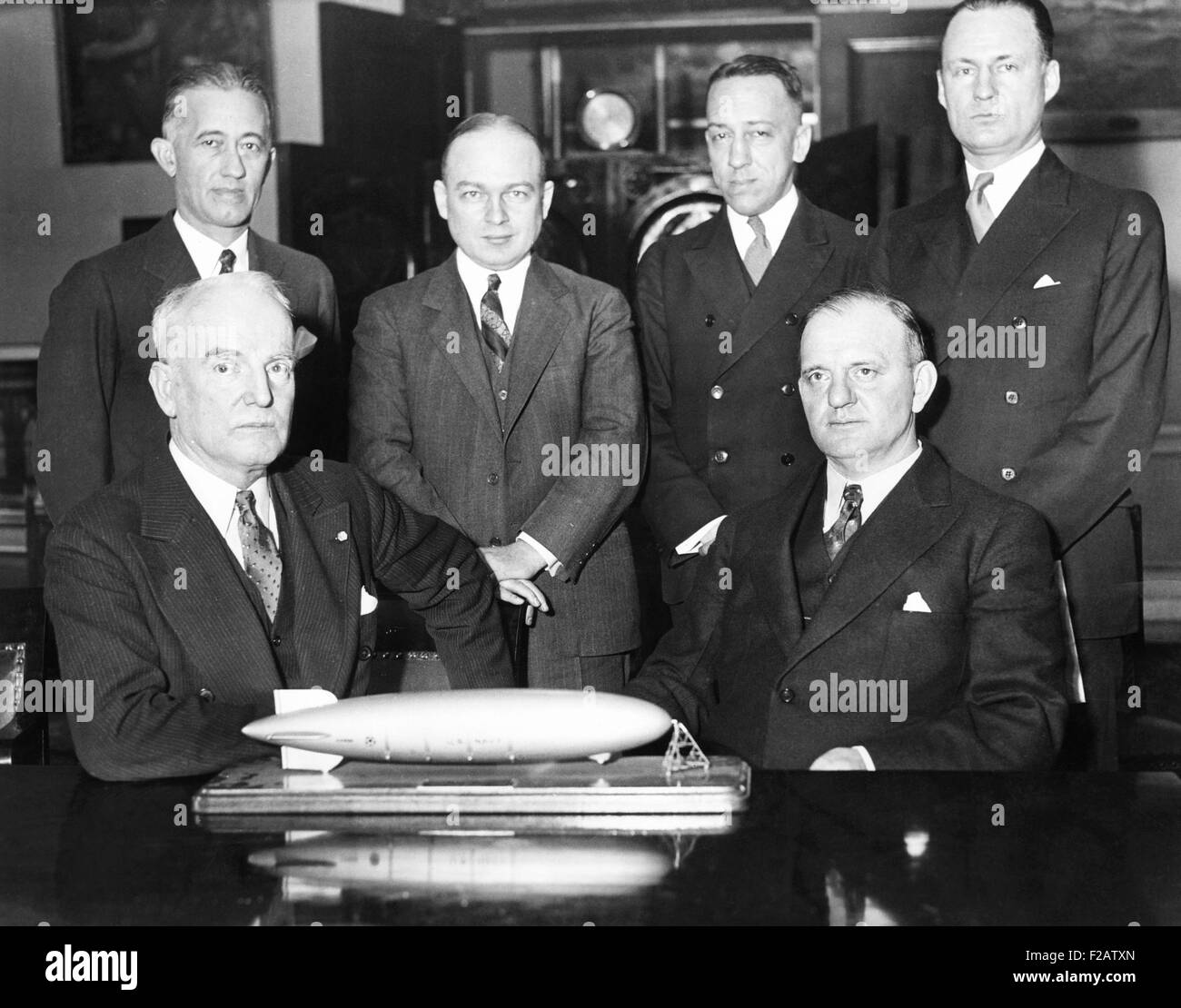 House Naval Affairs Committee, investigating rumored defects in the dirigible, USS Akron. Jan. 20, 1932. Adm. William Moffett (seated, left), was killed with 72 other men when the Akron crashed 14 months later. Seated, L-R: Adm. William Moffett, and Rep. Carl Vinson. Standing, L-R: Cmdr. R. D. Weyerbacher; Cmdr. G Fulton; Lieut. T. G. W. Settle; and Commander C. E. Rosendahl. (CSU 2015 11 1556) Stock Photo