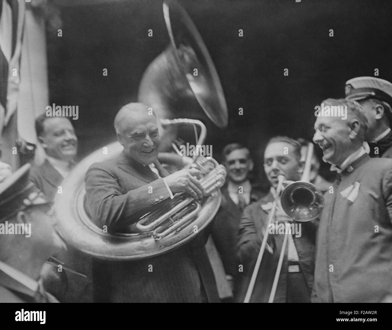 Republican Presidential nominee Warren Harding encircled by a sousaphone. August 1920. This created an amusing image for his 'front porch' campaign in 1920. (CSU 2015 11 1466) Stock Photo