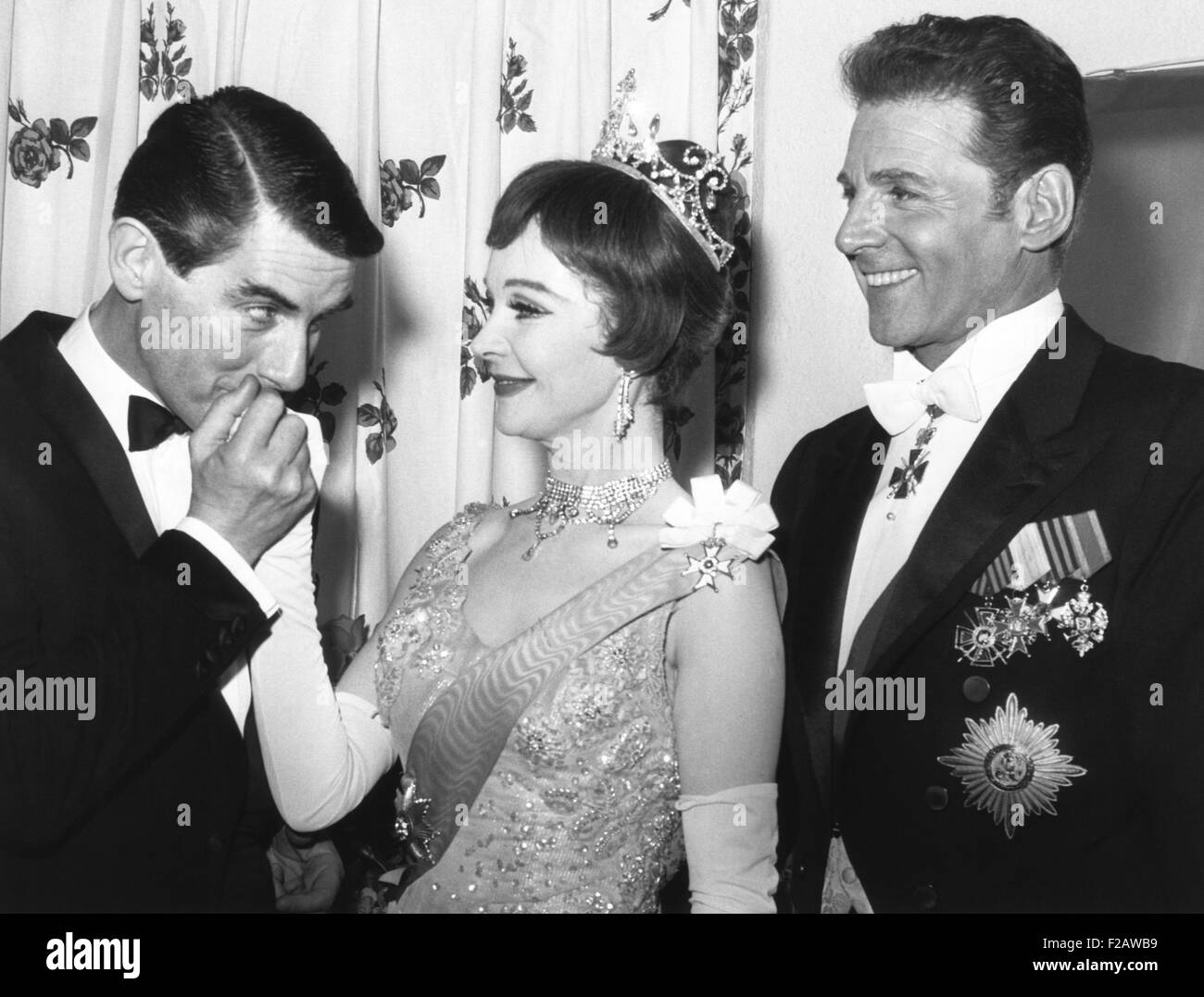 Director Peter Glenville kisses hand of Vivien Leigh's hand with actor Jean Pierre Aumont at right. March 18, 1963. It was the opening night of the Broadway musical TOVARICH, which ran for 264 performances and won Leigh the Tony Award for Best Actress. (CSU 2015 11 1436) Stock Photo