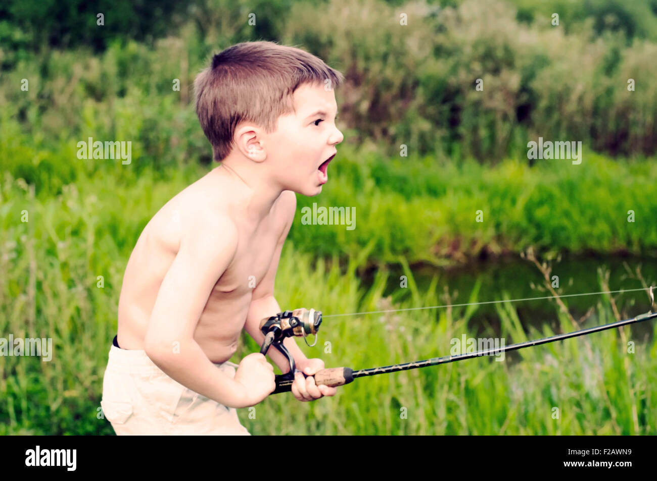 Passionate Angler boy fishing Stock Photo