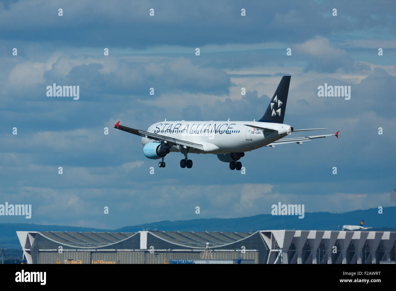 FRANKFURT AM MAIN, GERMANY - SEPTEMBER 4, 2015: Austrian Airbus 320 OE-LBX landing on runway 25L. Unofficial spotting in Fraport Stock Photo