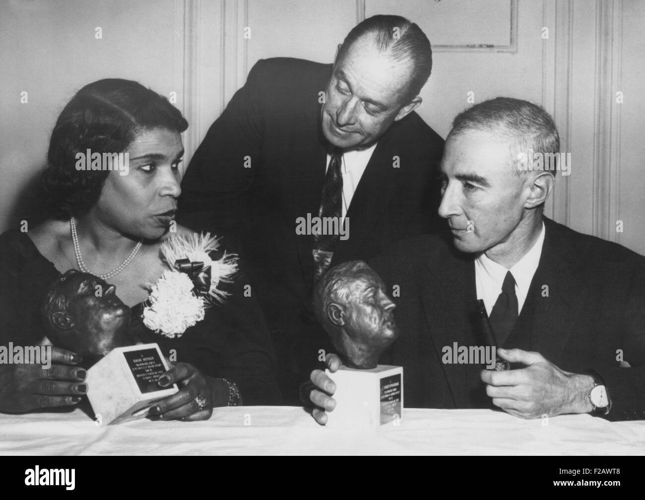 Concert singer Marian Anderson and physicist Dr. J. Robert Oppenheimer honored. Both were cited for 'distinguished service to the principles of American democracy' at Roosevelt University's 'Second Decade' dinner in Chicago. May 22, 1956. In center is Dr. Edward Sparling, President of the University. (CSU 2015 11 1206) Stock Photo