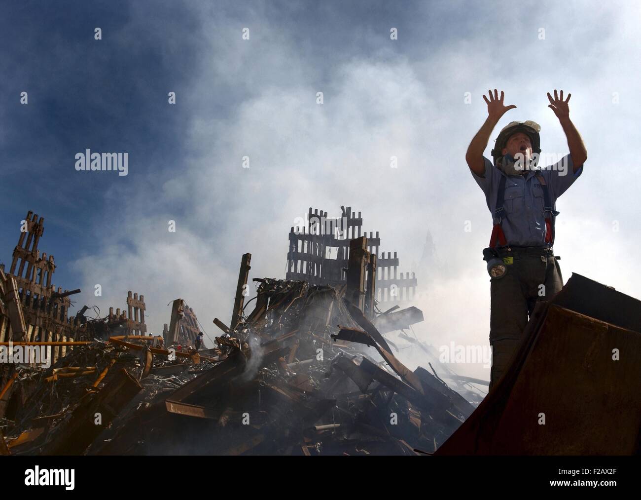 NYC Fireman signals for 10 more rescue workers to come into the rubble of the Ground Zero. Sept. 15, 2001. World Trade Center, New York City, after September 11, 2001 terrorist attacks. U.S. Navy Photo by Journalist 1st Class Preston Keres. (BSLOC 2015 2 79) Stock Photo