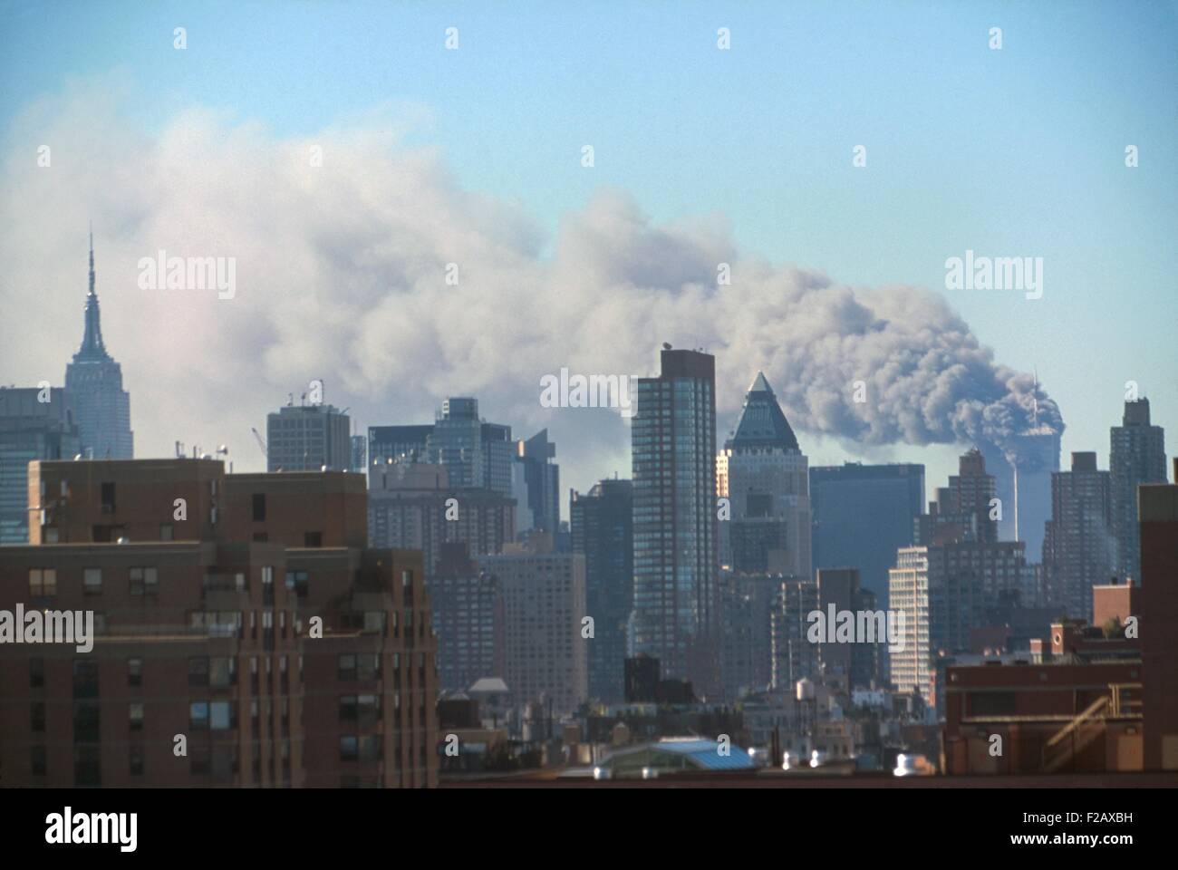 Smoke billowing from the Twin Towers following September 11th terrorist attack on World Trade Center. Photo taken from the Midtown west near 60th street within the first 72 minutes of the attack. New York City, Sept. 11, 2001. (BSLOC 2015 2 39) Stock Photo