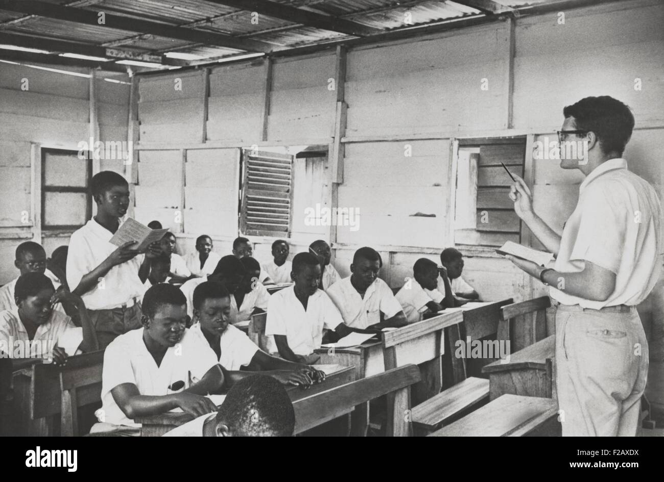 Peace Corpsman teaches English in Ghana. The students are all young men or teenagers in a simple schoolhouse. April 18, 1962. (BSLOC 2015 2 230) Stock Photo