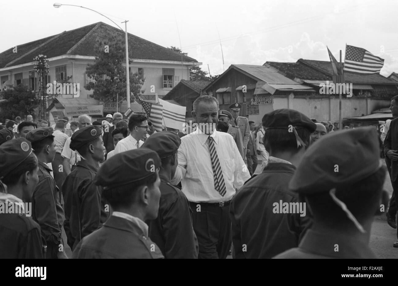 Vice-President Lyndon Johnson among group of Vietnamese soldiers and Americans. President Kennedy increased American forces to 12,000 U.S. military advisors in Vietnam by 1962. Saigon, South Vietnam, May 12, 1962. (BSLOC 2015 2 209) Stock Photo