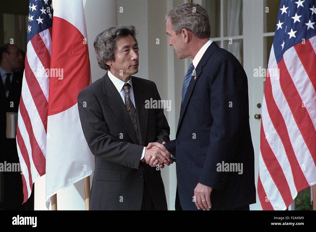 President George W. Bush shakes hands with Prime Minister Junichiro Koizumi of Japan. Sept. 25, 2001. Operation Enduring Freedom would start combat in Afghanistan on October 7, 2001. Japan would be a participant providing humanitarian aid. (BSLOC 2015 2 169) Stock Photo