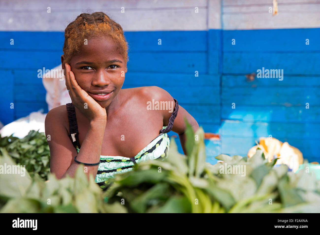 Close up portrait of Malagasy girl selling vegetables at market in Belo sur Tsiribihina, Menabe, Madagascar, Southeast Africa Stock Photo