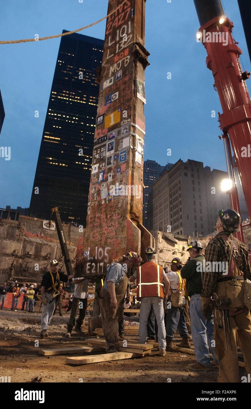 Construction workers maneuver the last piece of debris removed from Ground Zero. May 28, 2002. It was the 30-foot 'Column Number 1001B' of Two World Trade Center (South Tower). The steel beam, one of 47 that held up the South Tower, was plastered with mass cards, rosary beads, flags, photos of missing innocents, and letters from children to parents who would never be coming home. It is in the National Sept. 11 Memorial & Museum. U.S. Navy Photo by Bob Houlihan (BSLOC 2015 2 124) Stock Photo