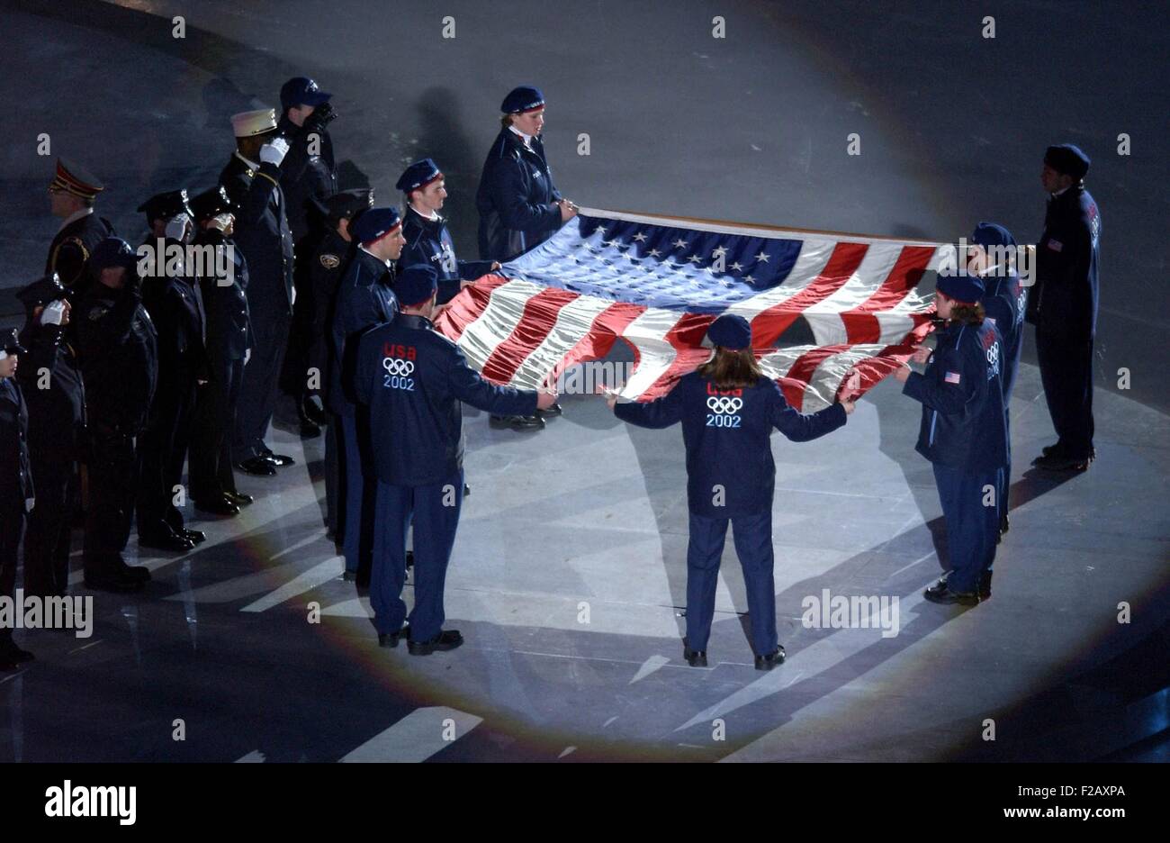 The US Olympic Team holds the American flag that flew over the Ground Zero on Sept. 11, 2001. Firefighters took the flag from a Stock Photo