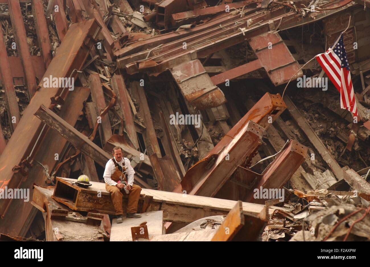 Solo firefighter sitting on a beam in the wreckage of the World Trade Center, Sept. 28, 2001. New York City, after September 11, 2001 terrorist attacks. (BSLOC 2015 2 109) Stock Photo
