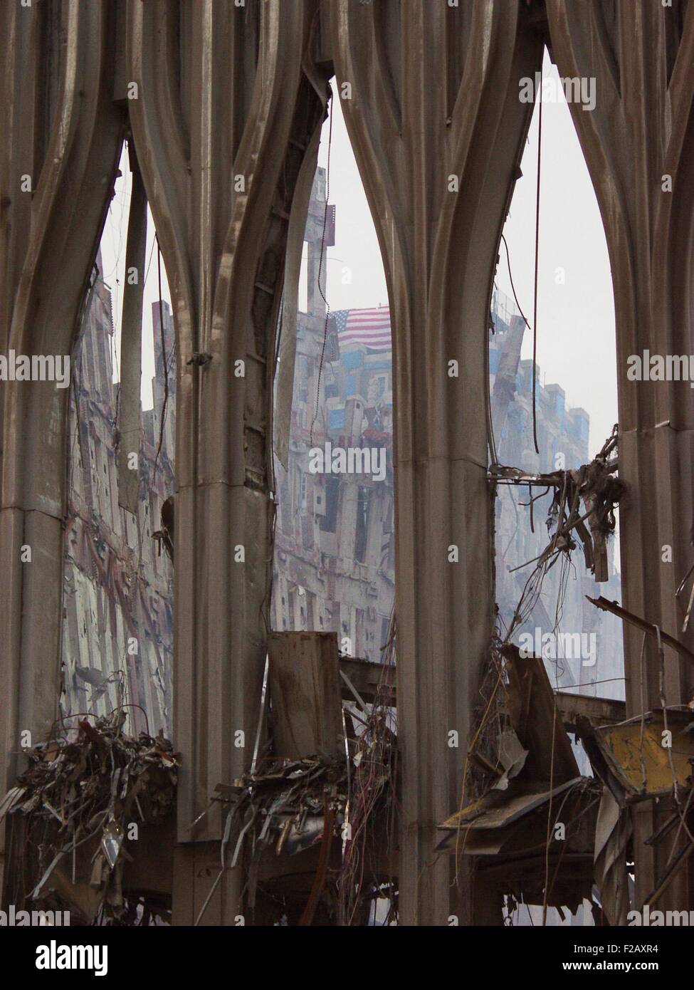 Fragment of the façade of WTC 1, the South Tower façade on Sept. 21, 2001. Through the center arch a flag can be seen on the damaged New York Telephone (now Verizon) Building. World Trade Center, New York City, after September 11, 2001 terrorist attacks. (BSLOC 2015 2 102) Stock Photo