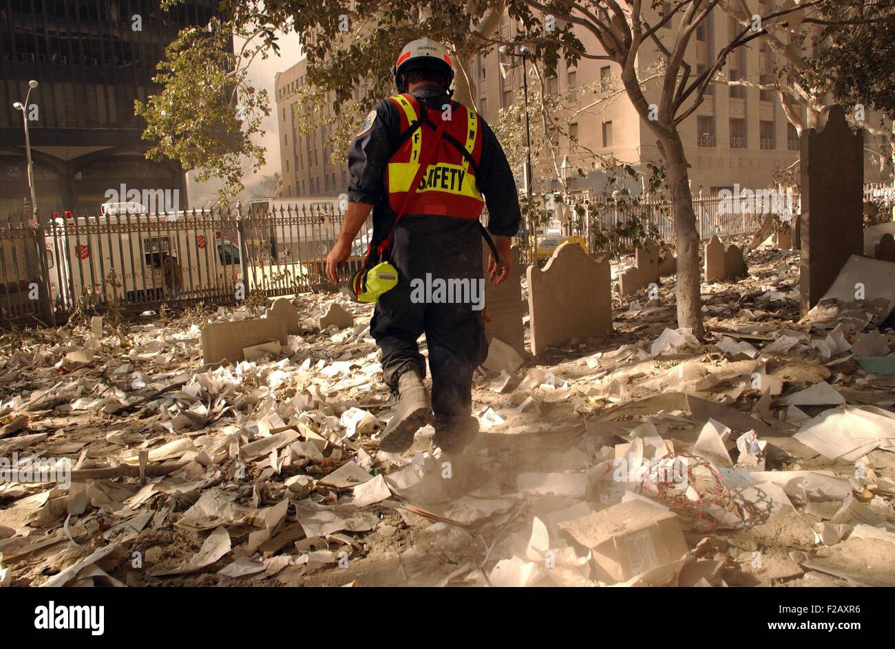 NYC firefighter walks among the old headstones at Trinity Church Cemetery in lower Manhattan. Sept. 19, 2001. The church grounds contain the graves of notable 18th and 19th century New Yorkers, including Alexander Hamilton and John Jacob Astor. New York City, after September 11, 2001 terrorist attacks. (BSLOC 2015 2 100) Stock Photo
