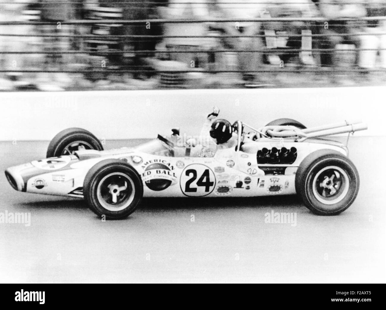 Graham Hill, waves as his car streaks toward the finish line to win the Indianapolis 500. May 30, 1966. The Golden Anniversary of speedway classic was Hill's first race at Indianapolis. (CSU 2015 9 977) Stock Photo