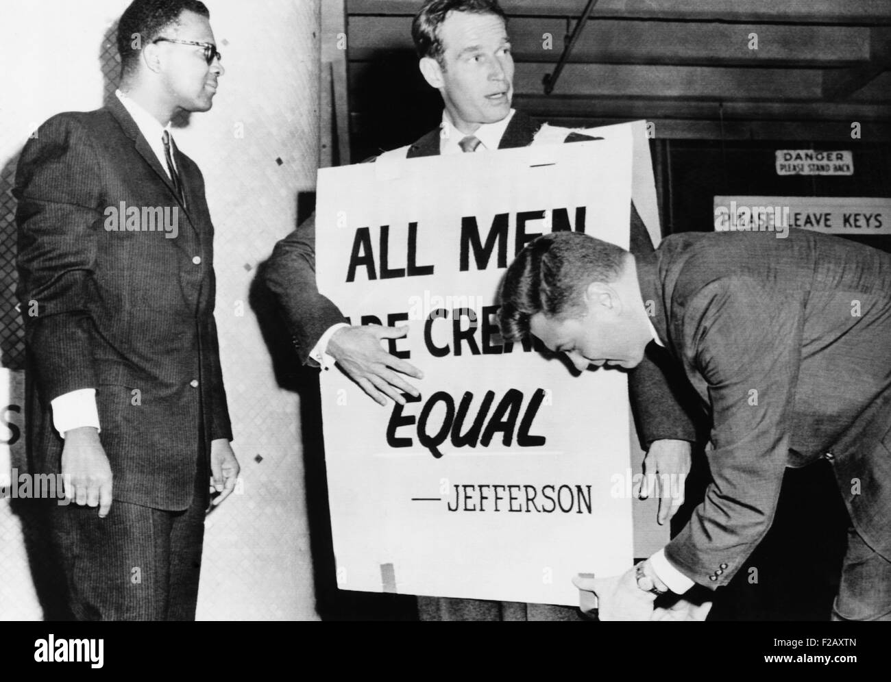 Actor Charlton Heston adjusts a sandwich board for a civil rights demonstration. Oklahoma City, May 27, 1961. His sign reads, 'All Men are Created Equal.' (CSU 2015 9 963) Stock Photo